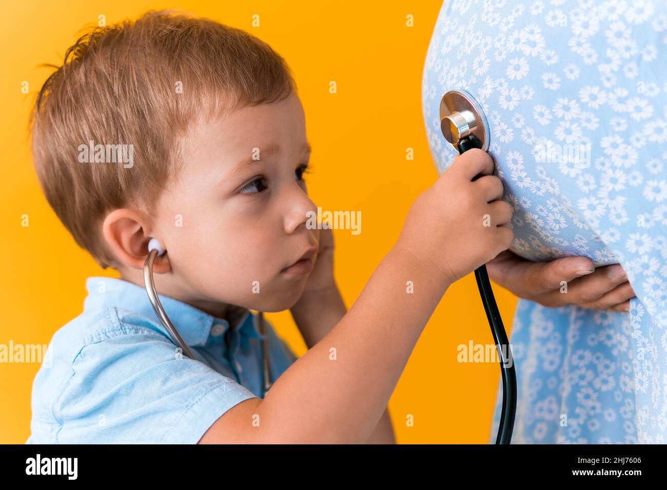 Motherhood, hot summer - croped portrait pregnant mother unrecognizable  woman blue dress little boy son sibling treat pregnant mom role play Stock  Photo - Alamy