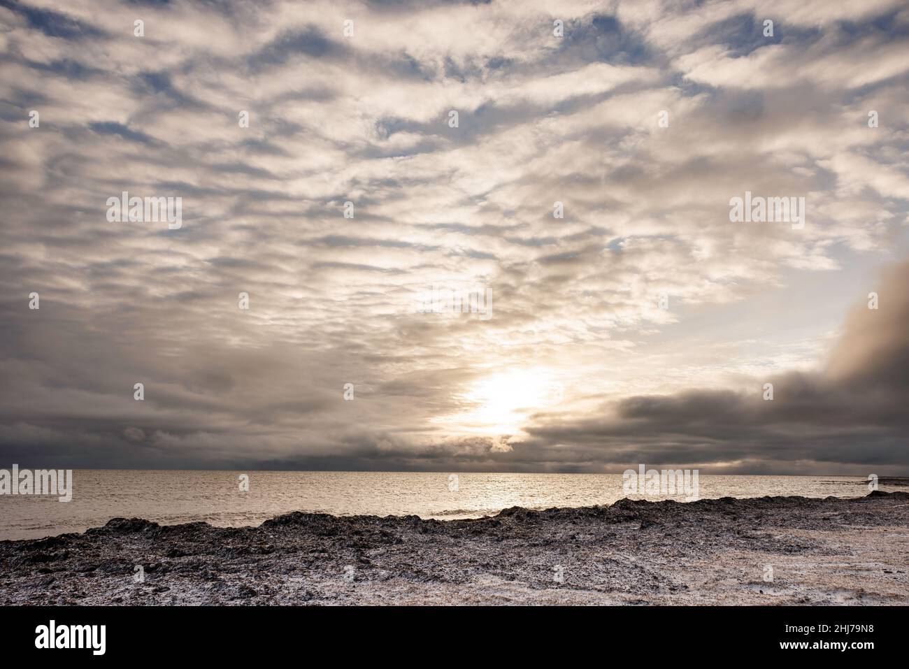 Snow on the shore as sunrises over the water of the Hudson Bay, Canada Stock Photo