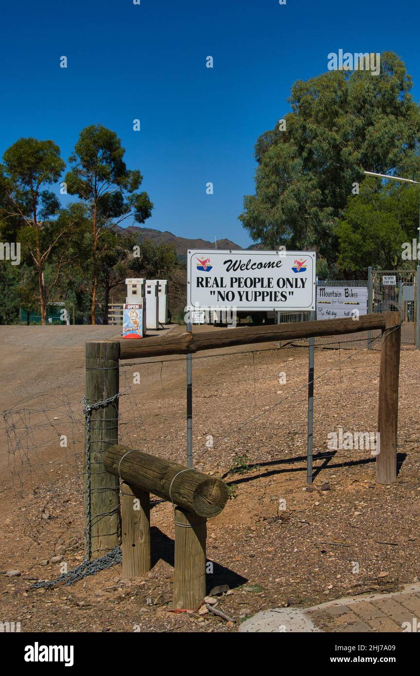 Yuppies not welcome. Sign on the gate of a small tourist business in the Flinders Ranges, Australia. Stock Photo