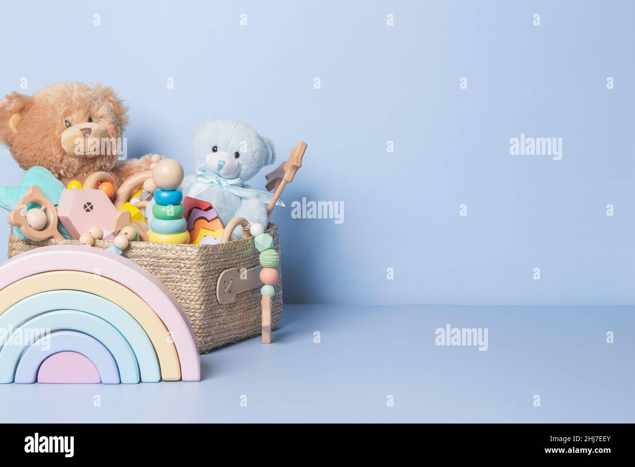 Toy box full of baby kid toys. Container with teddy bear, wooden