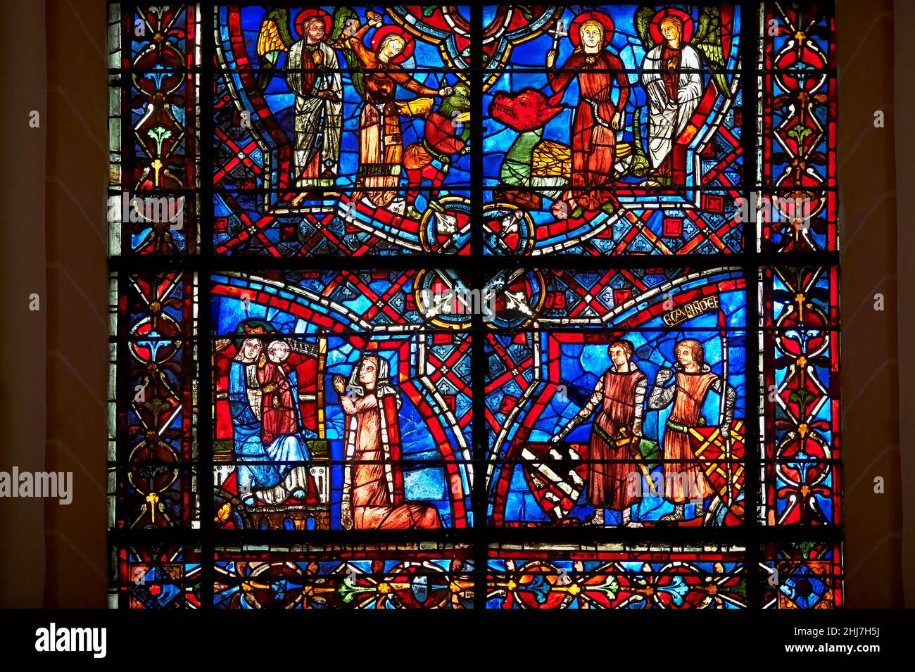 Medieval stained glass Window of the Gothic Cathedral of Chartres, France - dedicated to St Margret and St Catherine. Bottom left panel -  Margaret of Stock Photo