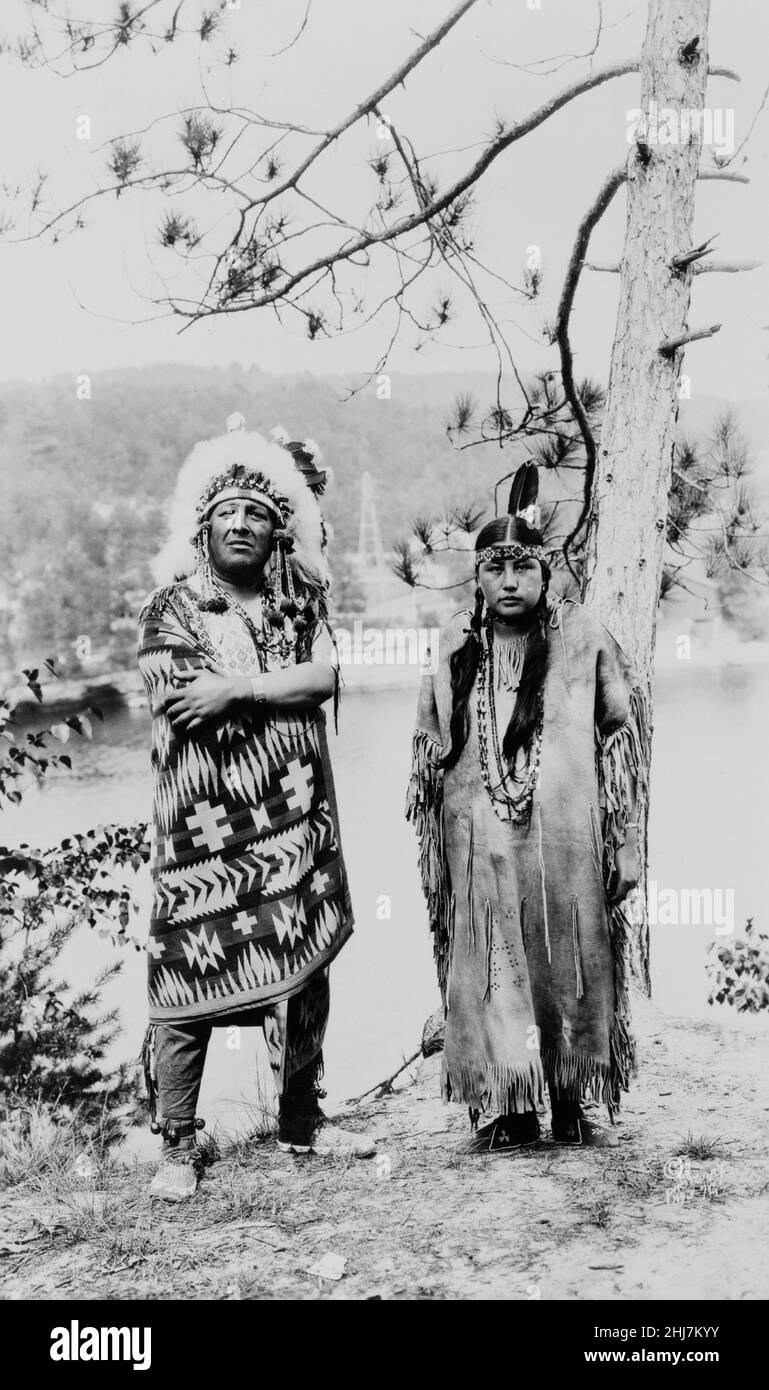 Winnebago(?) man and woman by river in Wisconsin. Antique and vintage photo - Native american / Indian / American Indian. C 1925. Stock Photo