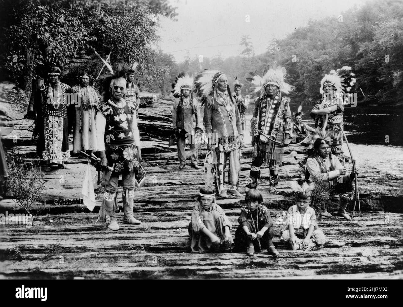 Native Americans, possibly Winnebago, on rocks at the Dells of the Wisconsin. C 1925. Stock Photo