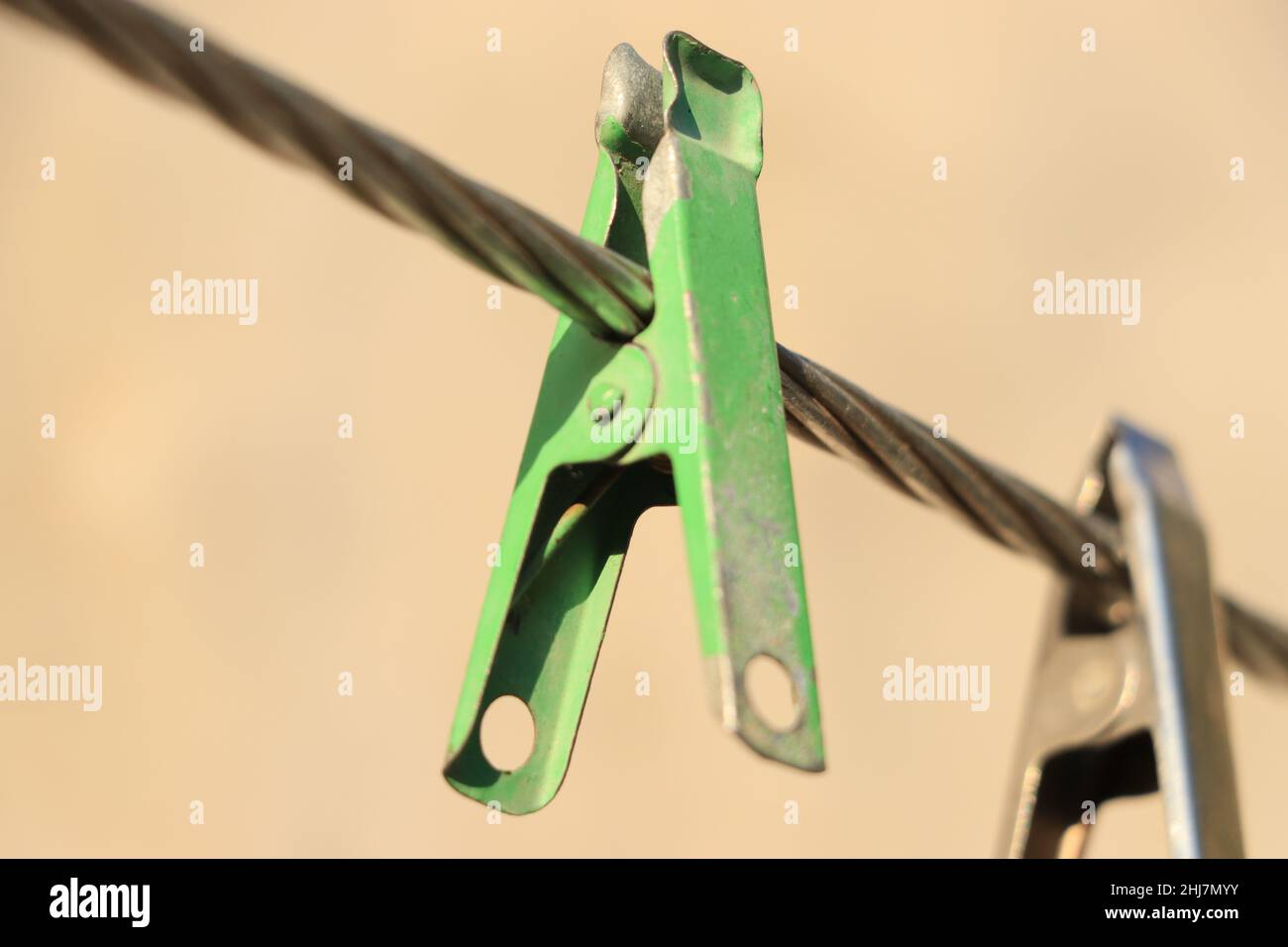 clothes pin hanging on wire. Stock Photo