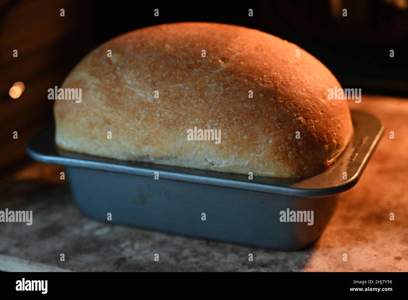 loaf of bread baking in the oven Stock Photo