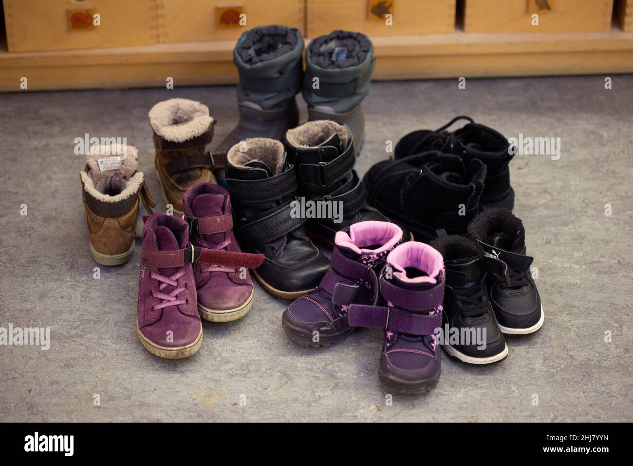Bielefeld, Germany. 26th Jan, 2022. Rubber boots with soil under the soles  are stuck in a rack for used boots at a daycare center (Kita). Pool tests  ("lollipop tests") are to be
