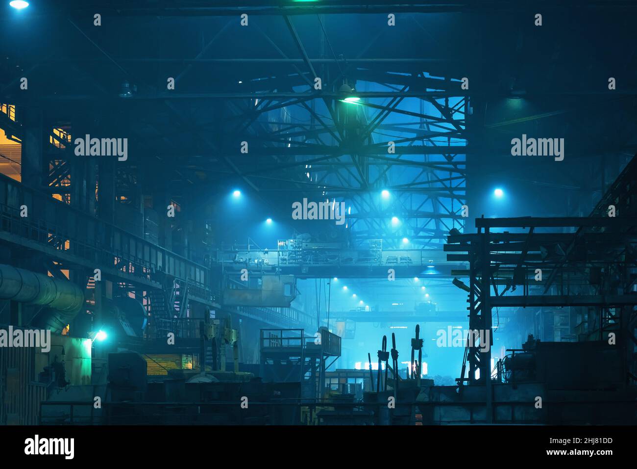 Interior of big industrial building inside in blue color. Factory hangar or workshop with steel constructions. Metallurgy plant. heavy industry. Stock Photo