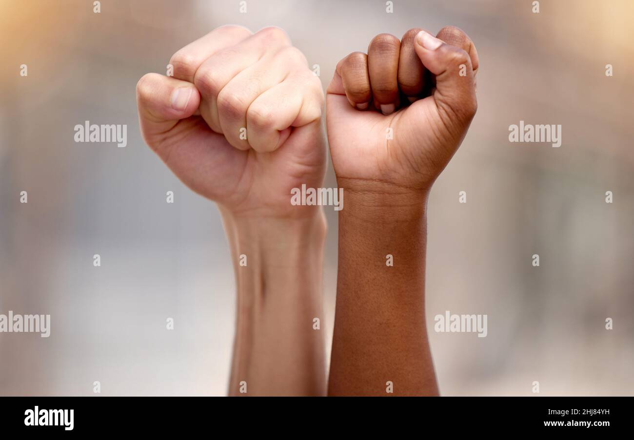 Standing together in support. Shot of two people protesting together in solidarity. Stock Photo