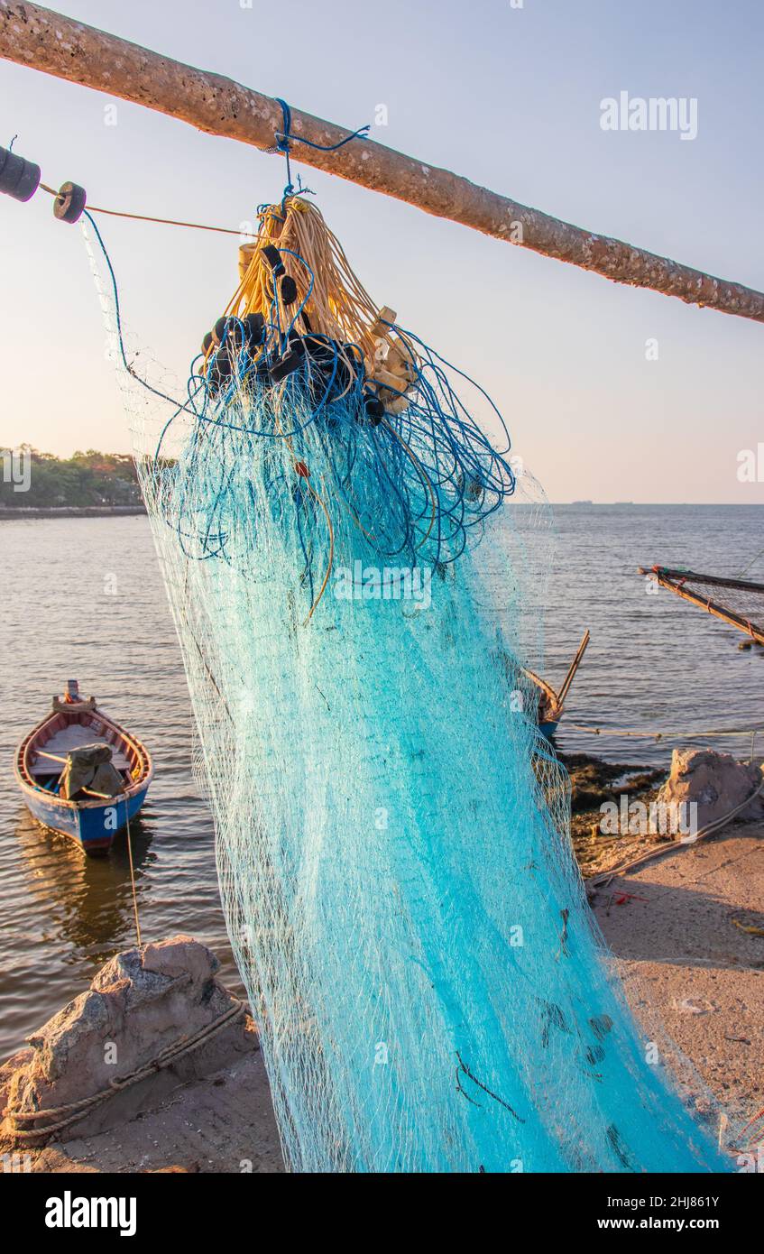 after the fish is caught, a fishing net is maintained directly at the pier,  arranged and hung on a pole Stock Photo - Alamy
