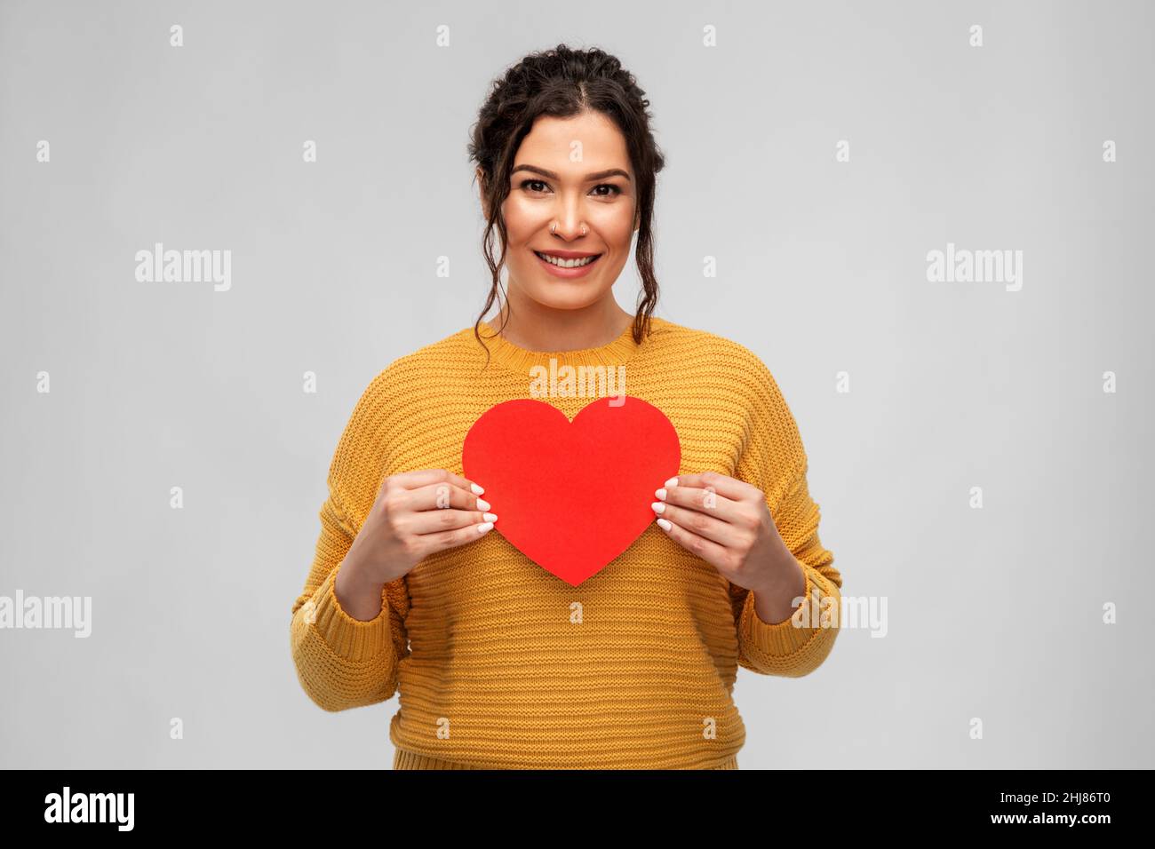 happy smiling young woman with red heart Stock Photo