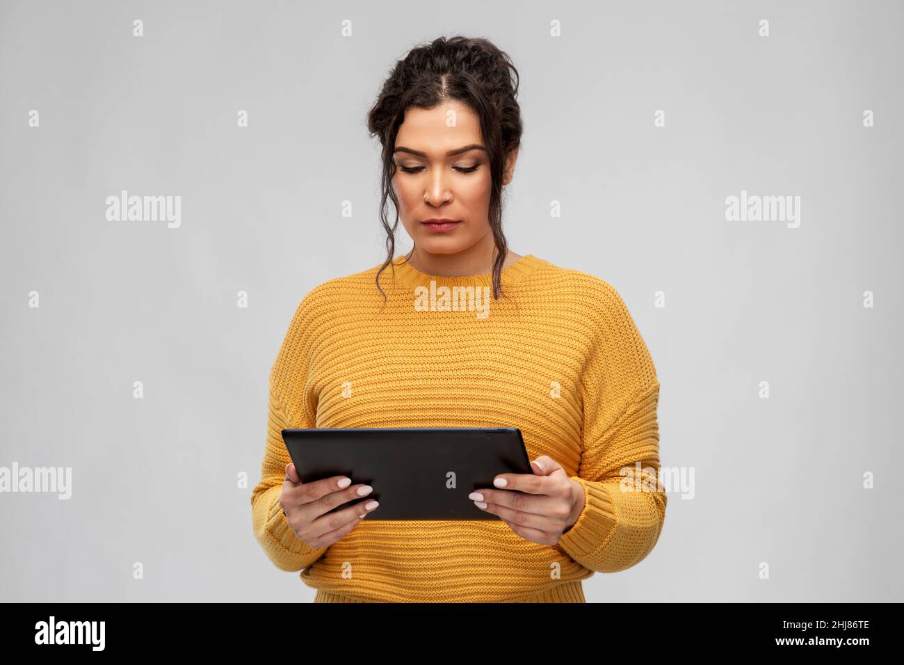 serious young woman using tablet pc computer Stock Photo