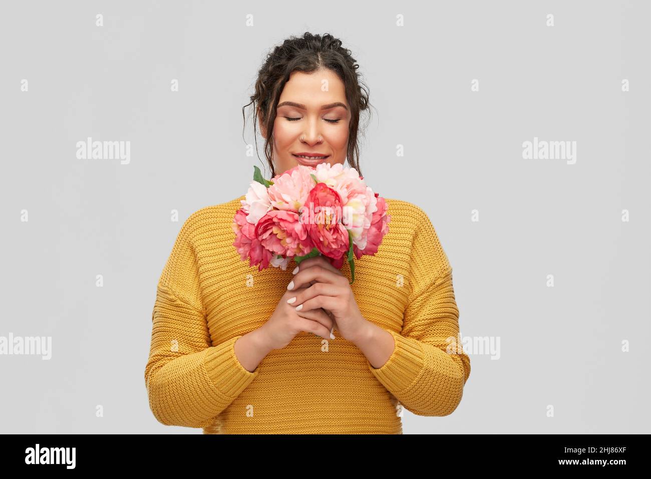 happy smiling young woman with bunch of flowers Stock Photo