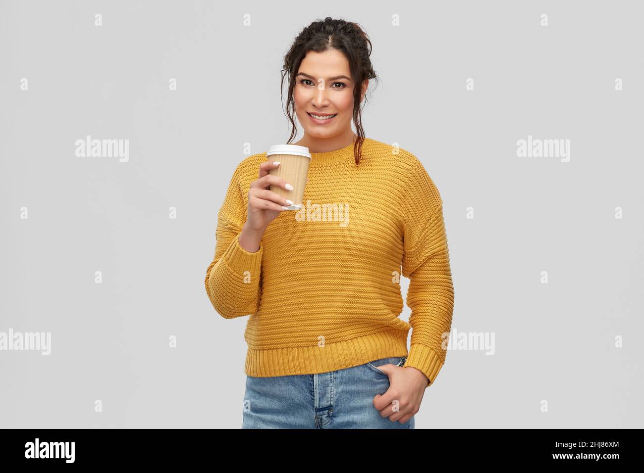 smiling woman with pierced nose holding coffee cup Stock Photo