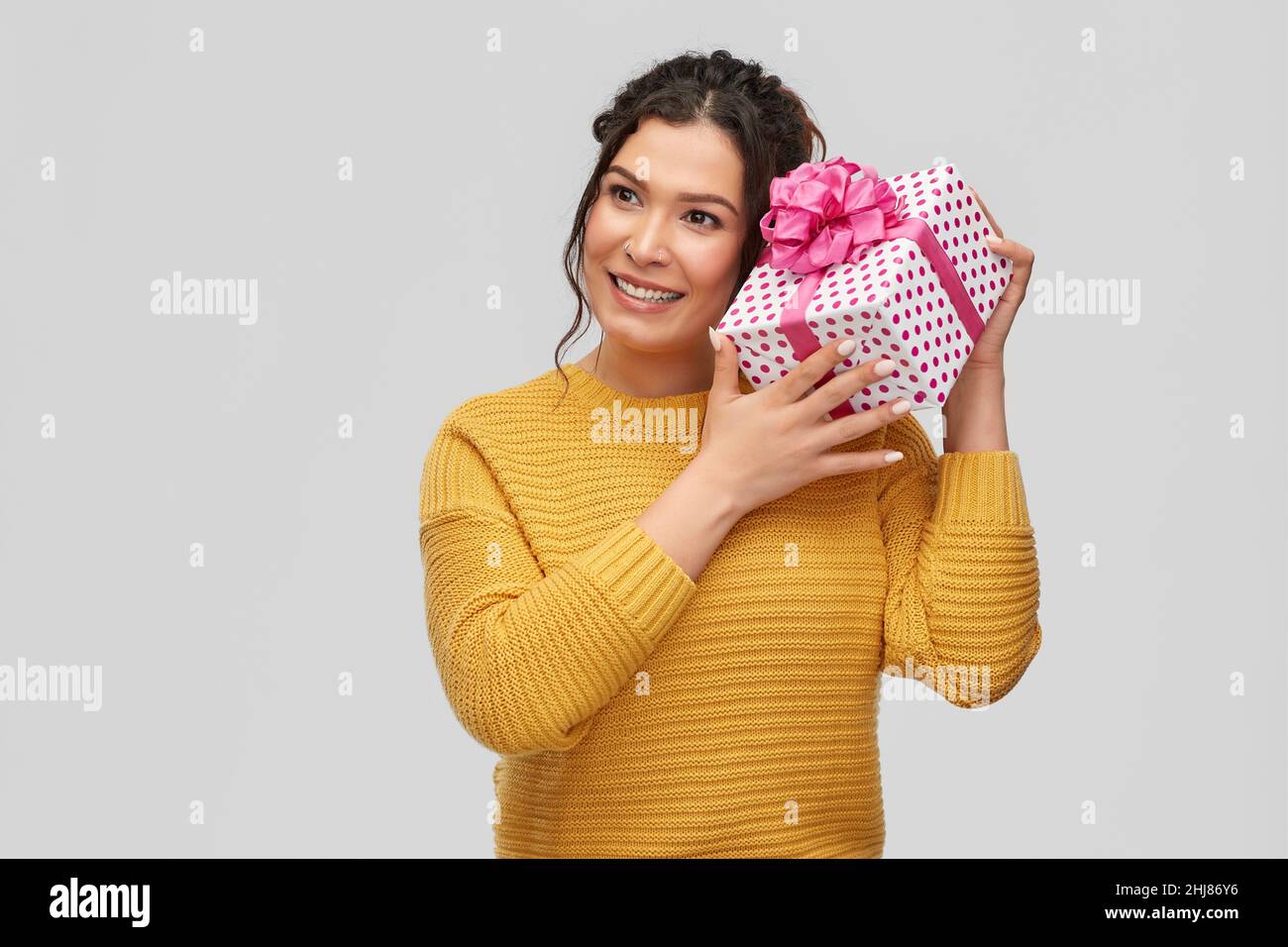 smiling young woman holding gift box Stock Photo