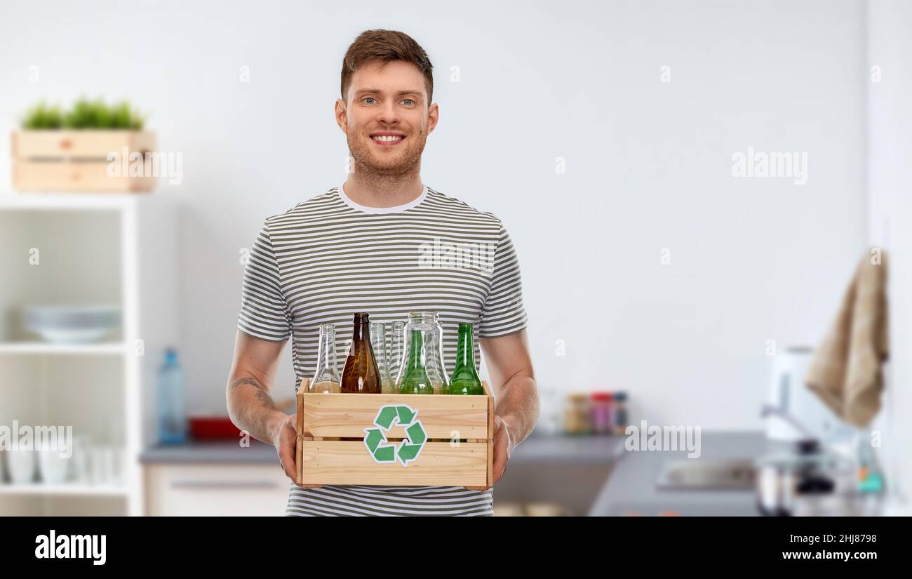 smiling young man sorting glass waste at home Stock Photo Alamy