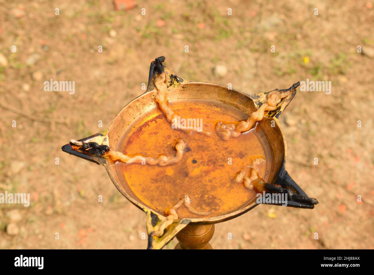 Oil lamp lighted during day time. An oil lamp is an object used to