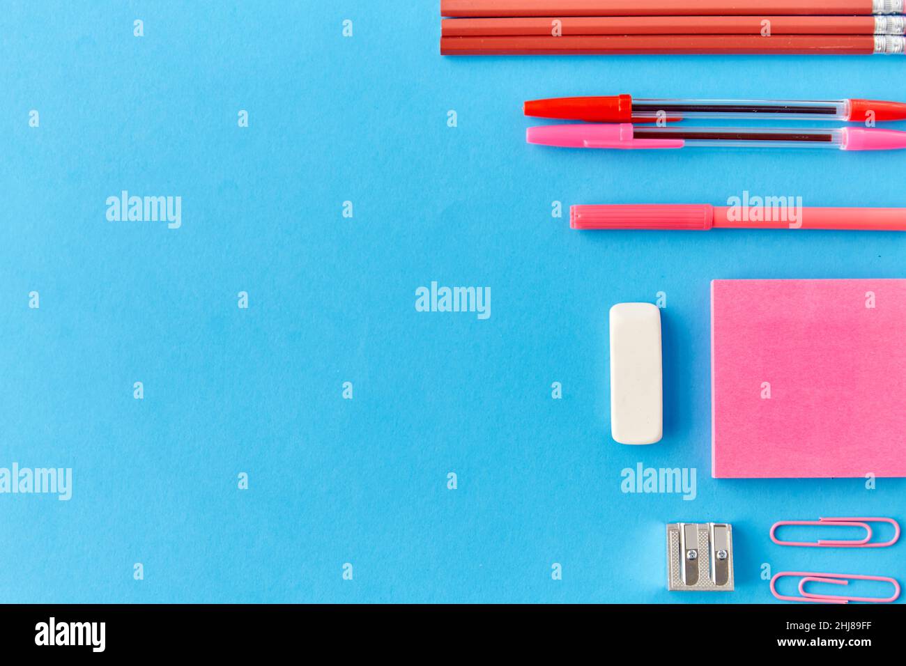 pink sticky notes, pens, pencils, clips and eraser Stock Photo - Alamy