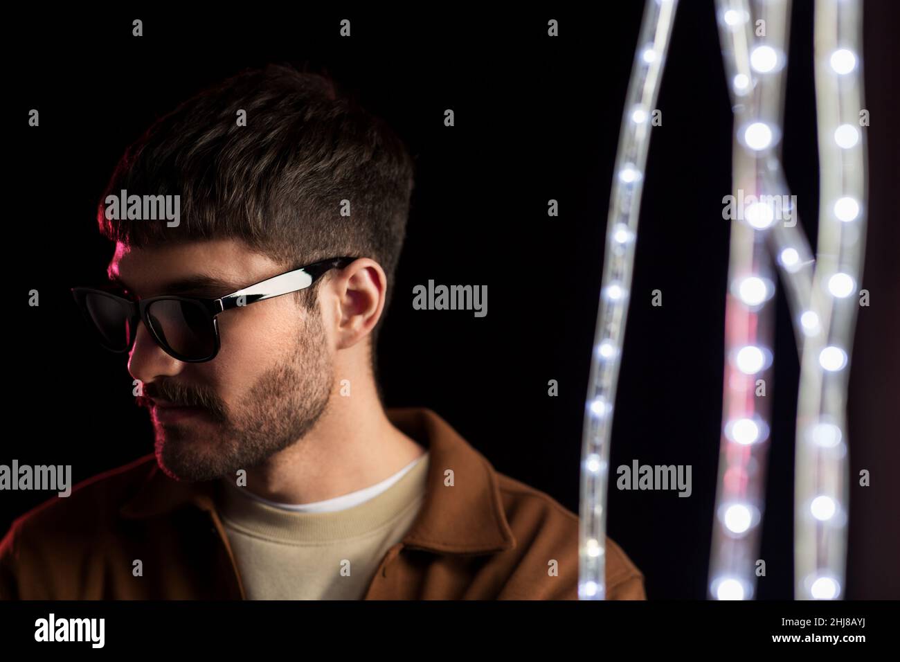 man in sunglasses over neon lights at Stock Photo Alamy