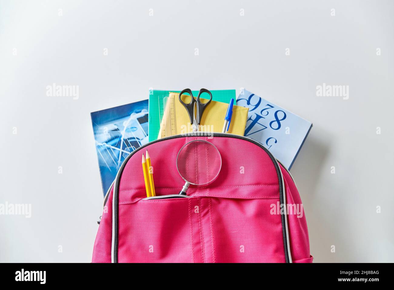 backpack with books and school supplies Stock Photo