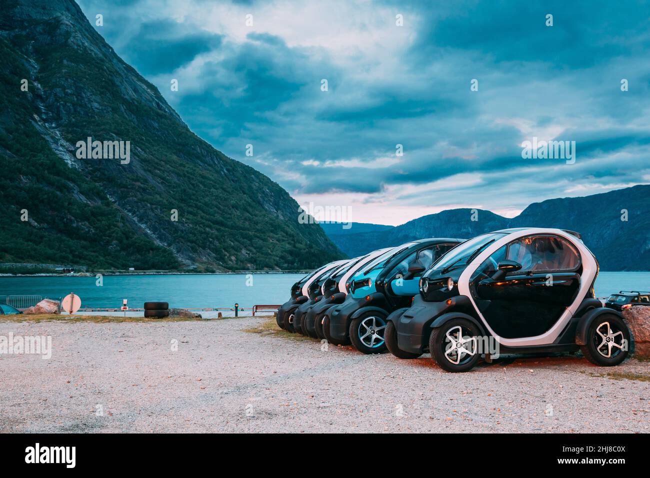 Many Black And Blue Colors Renault Z.E. Cars Parked In row. The Renault Z.E. or Zero Emission is a line of all-electric cars from Renault Stock Photo