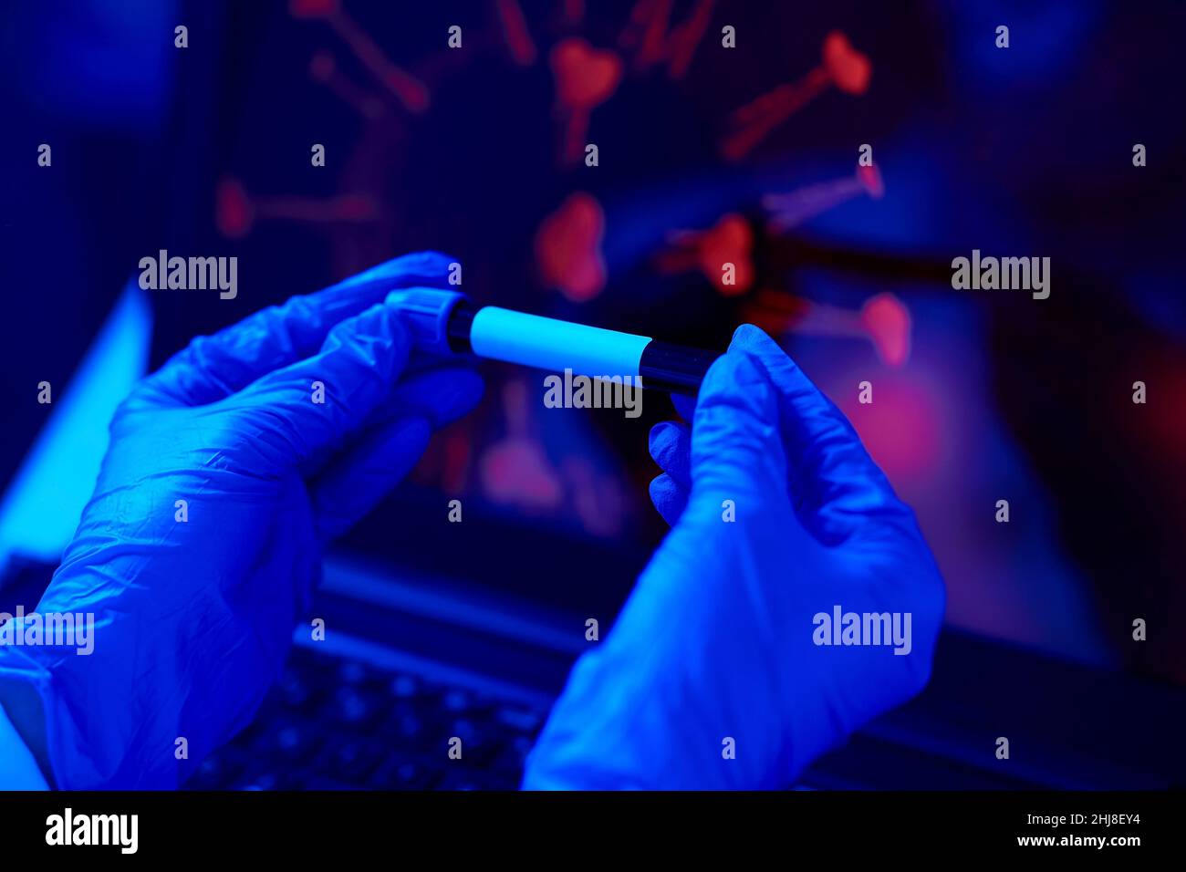 hand holding beaker with coronavirus blood test Stock Photo - Alamy