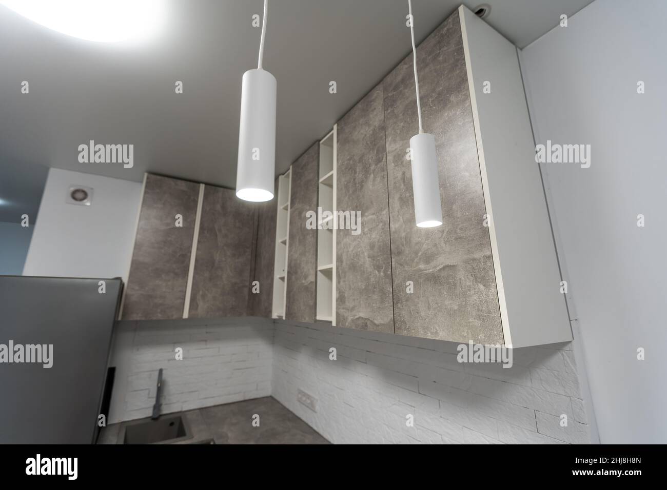 Modern kitchen with gray furniture and wooden floor Stock Photo - Alamy