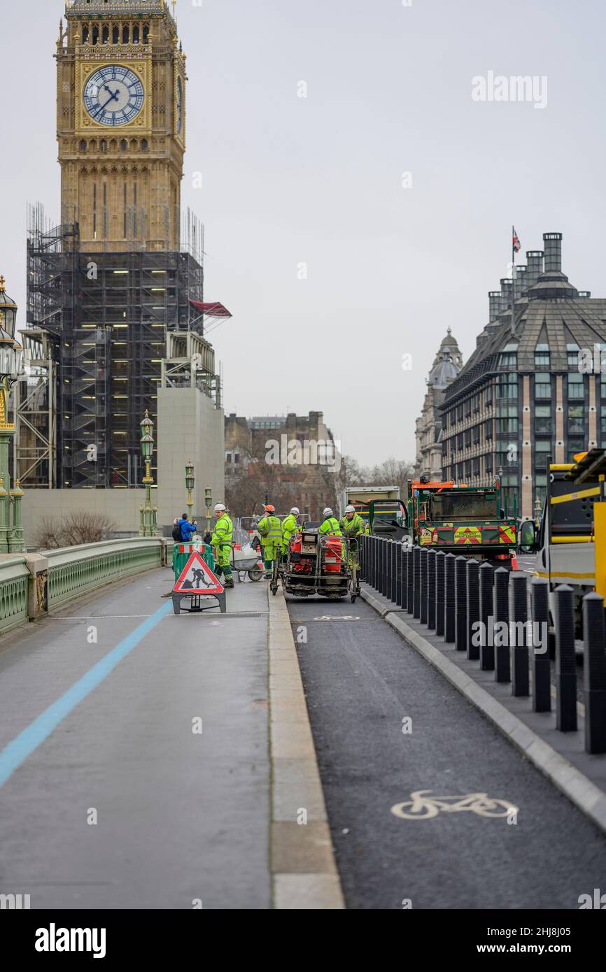 London, UK. 27 January 2022. A grey morning in the capital. Westminster Bridge has a new cycle lane being completed, isolated from the roadway Stock Photo