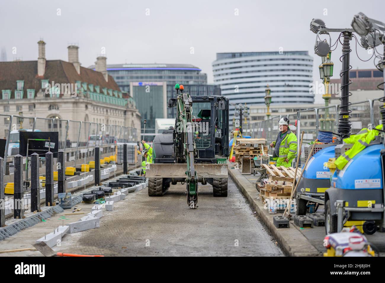 London, UK. 27 January 2022. Westminster Bridge has a new cycle lane being completed, isolated from the roadway traffic with bollards Stock Photo