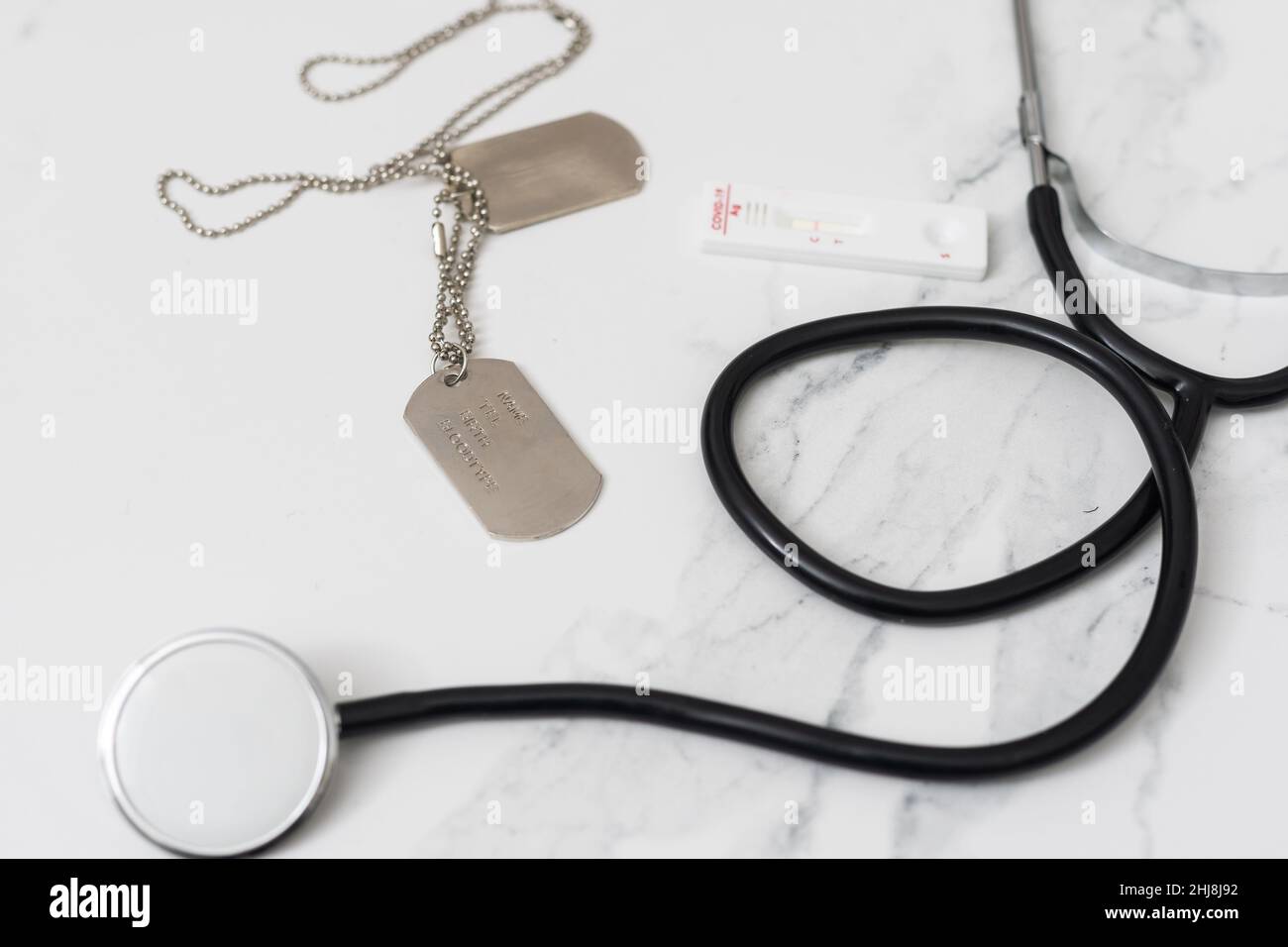 Military Health Care Concept. dog tags, stethoscope, and covid test