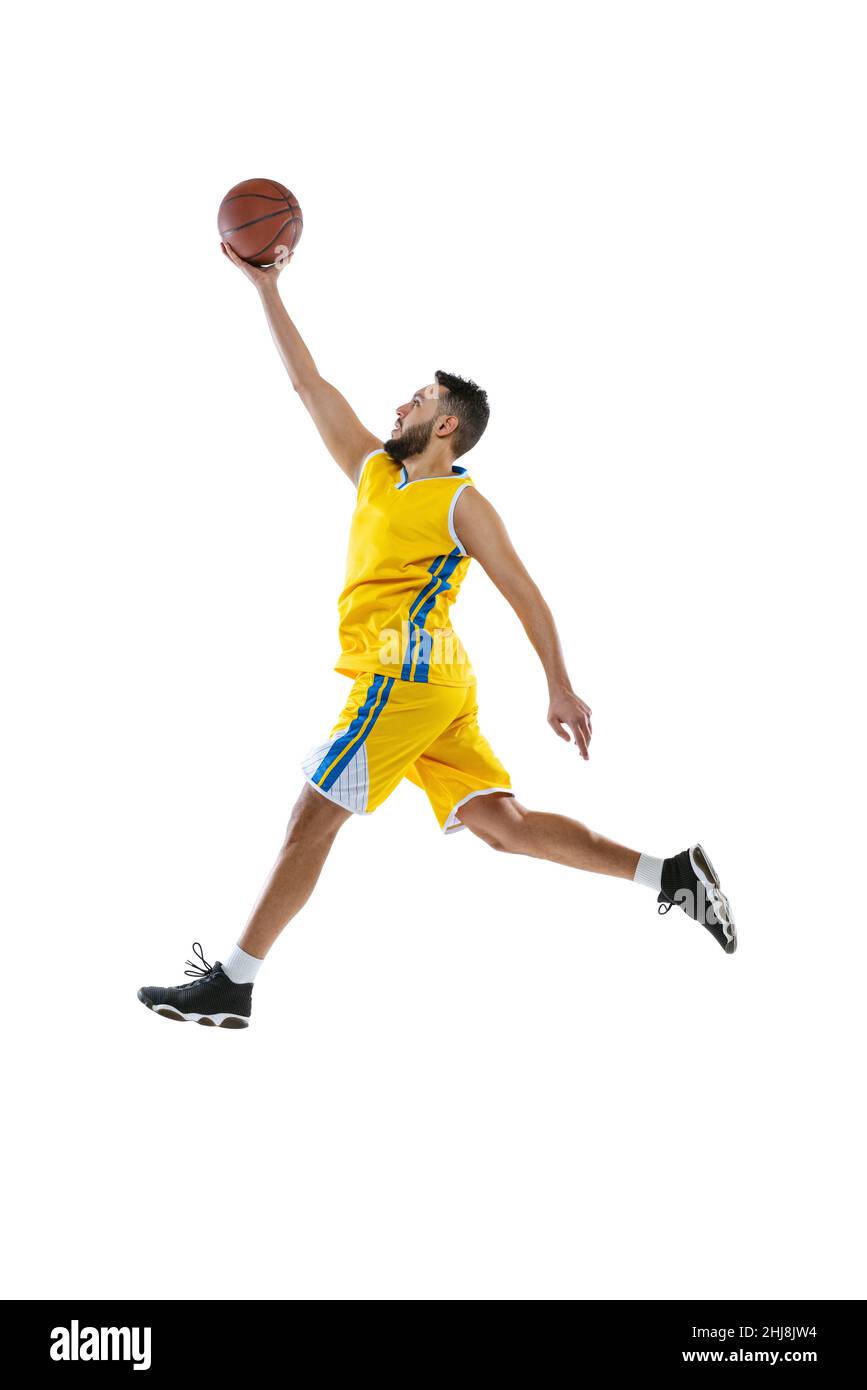 Dynamic portrait of professional basketball player jumping with ball