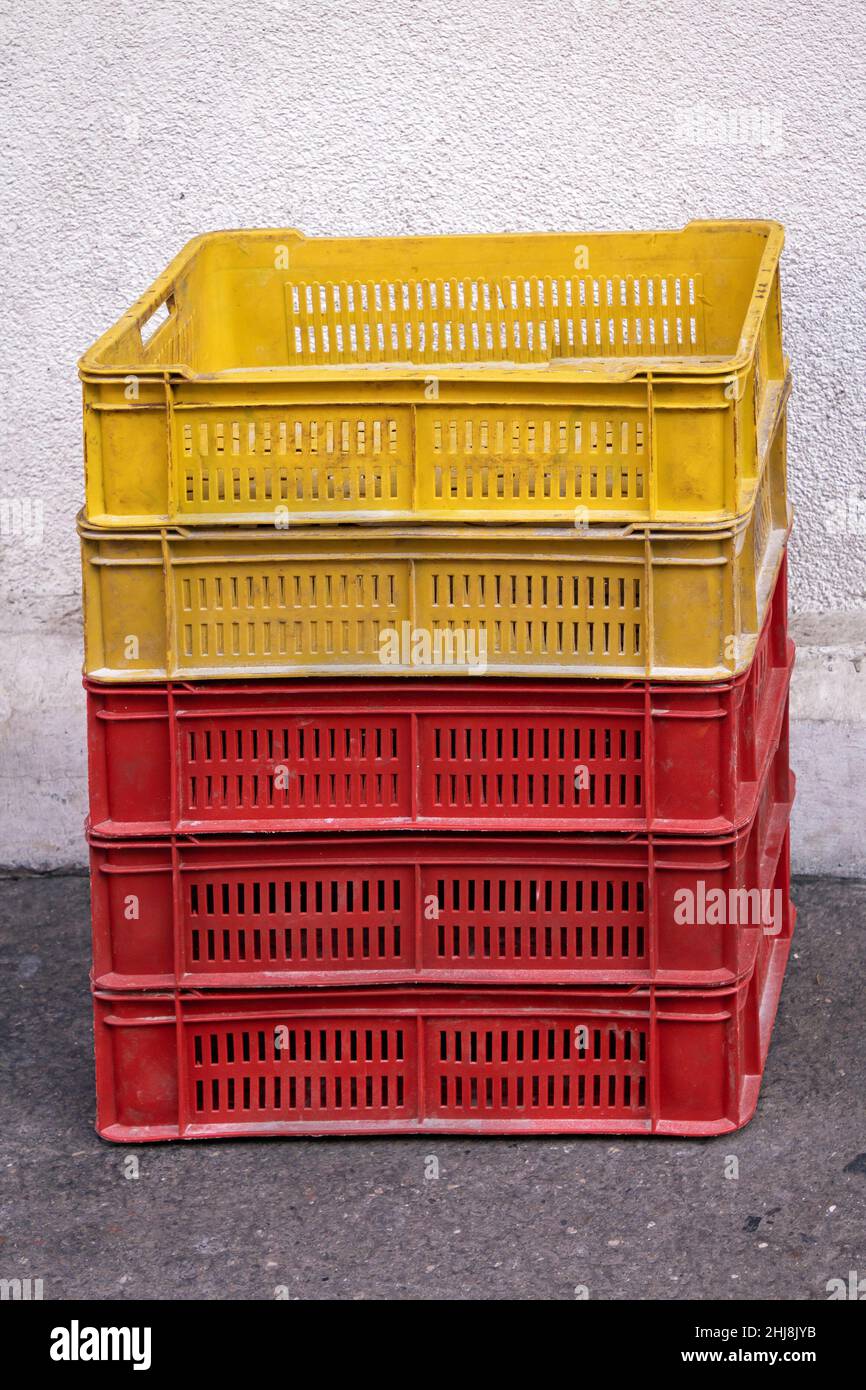 Stack of empty plastic crates on the ground pavement Stock Photo