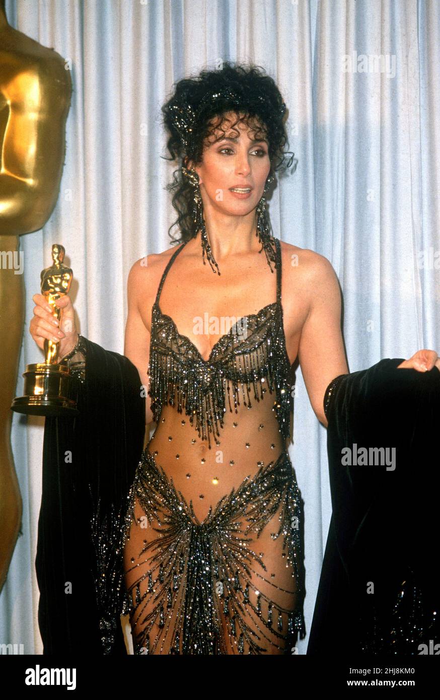 Cher at the Academy Awards for Best Actress for Moonstruck, 1988. Credit: Ron Wolfson / Rock Negatives / MediaPunch Stock Photo