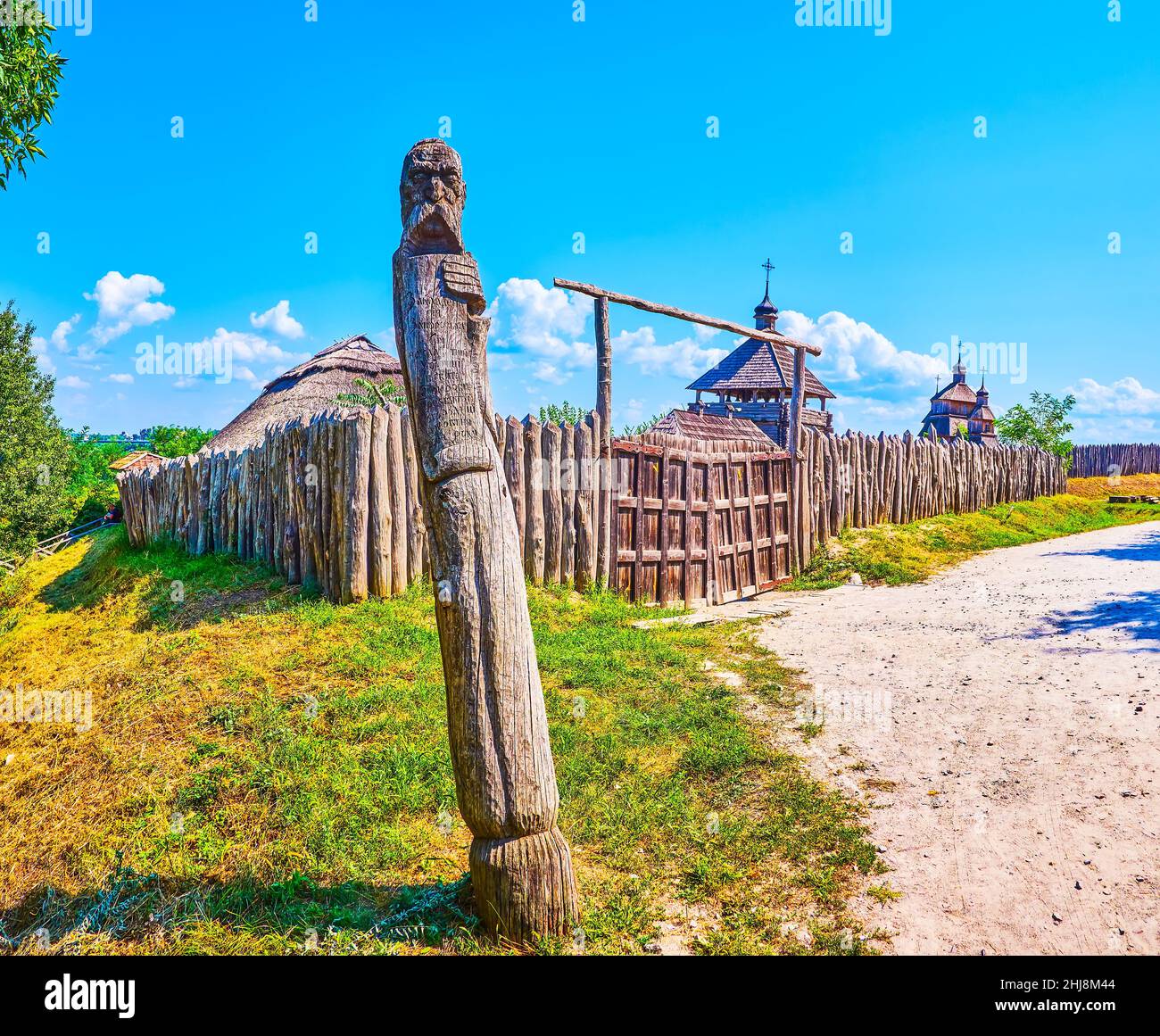 At the entrance to Zaporizhian Sich Fort located the wooden pillar with a bust of cossack and information of the complex, Zaporizhzhia, Ukraine Stock Photo