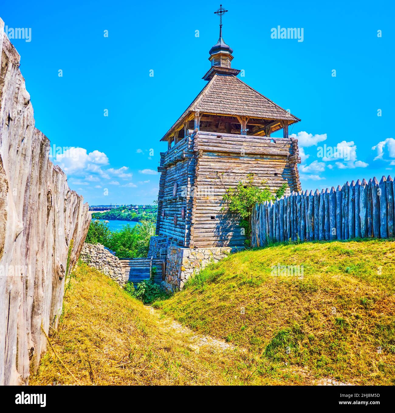 The pleasant walk along the wooden stockade of Zaporizhian Sich Fort observing magnificent defensive tower, Zaporizhzhia, Ukraine Stock Photo