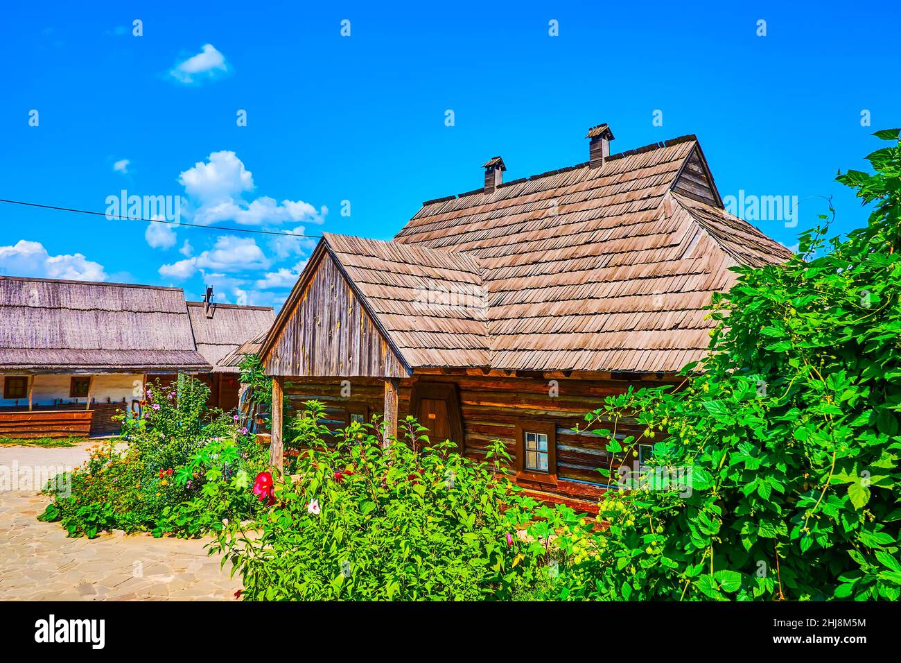 The timber house and blooming garden in Small Kish of Zaporizhian Sich Fort scansen in Zaporizhzhia, Ukraine Stock Photo
