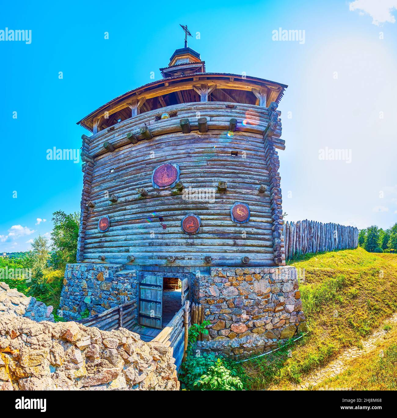 The high wooden defensive tower with stone foundation and stockade of Zaporizhian Sich Fort scansen in Zaporizhzhia, Ukraine Stock Photo