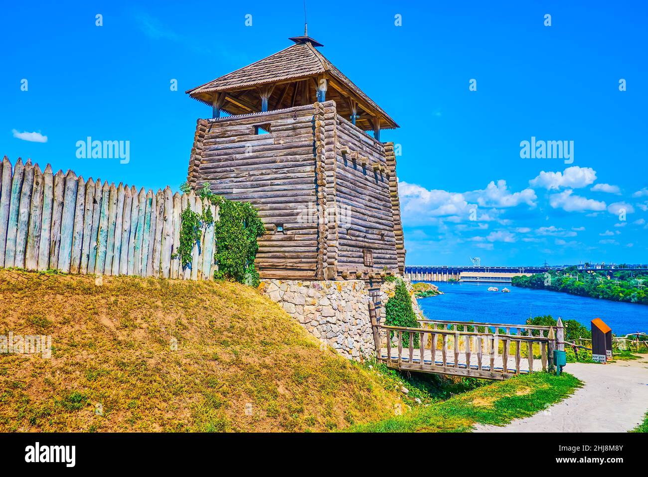 The wooden tower with the entrance bridge of Zaporizhian Sich Fort scansen and Dnieper river on background, Zaporizhzhia, Ukraine Stock Photo