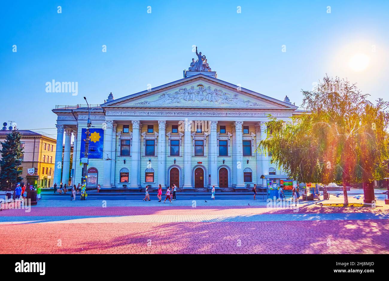 ZAPORIZHZHIA, UKRAINE - AUGUST 25, 2021: The facade of Vladimir Magar Dramatic Theater and the busy traffic in the Theater Square, on August 25 in Zap Stock Photo