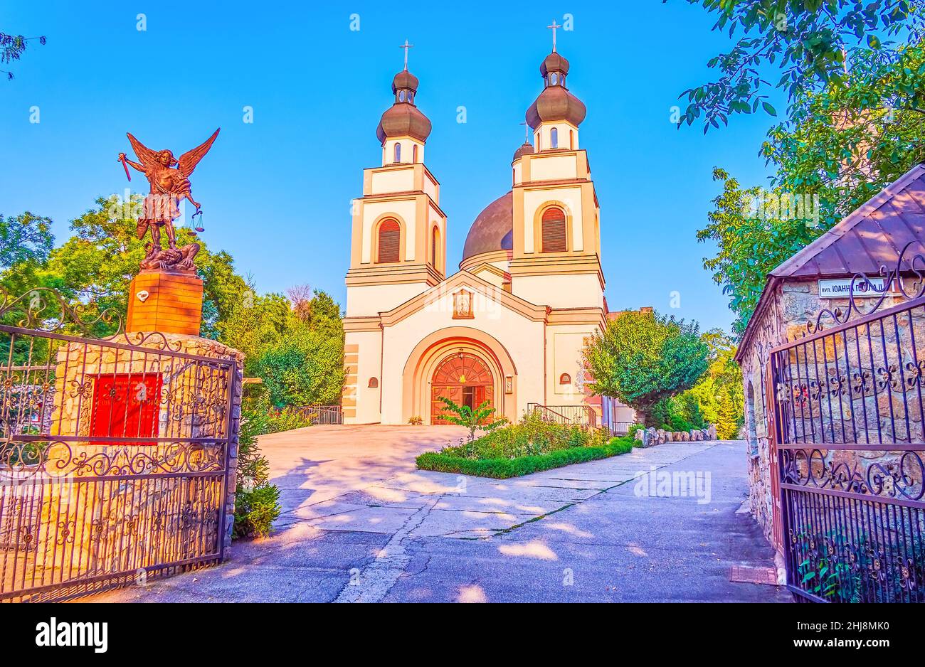The walk to Co-Cathedral of the Merciful Father throught the gates with sculpture of Archangel Michael, Zaporizhzhia, Ukraine Stock Photo