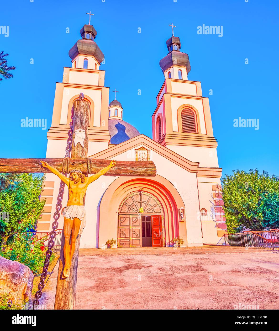 The bright sunset light illuminates facade of Co-Cathedral of the Merciful Father, Zaporizhzhia, Ukraine Stock Photo