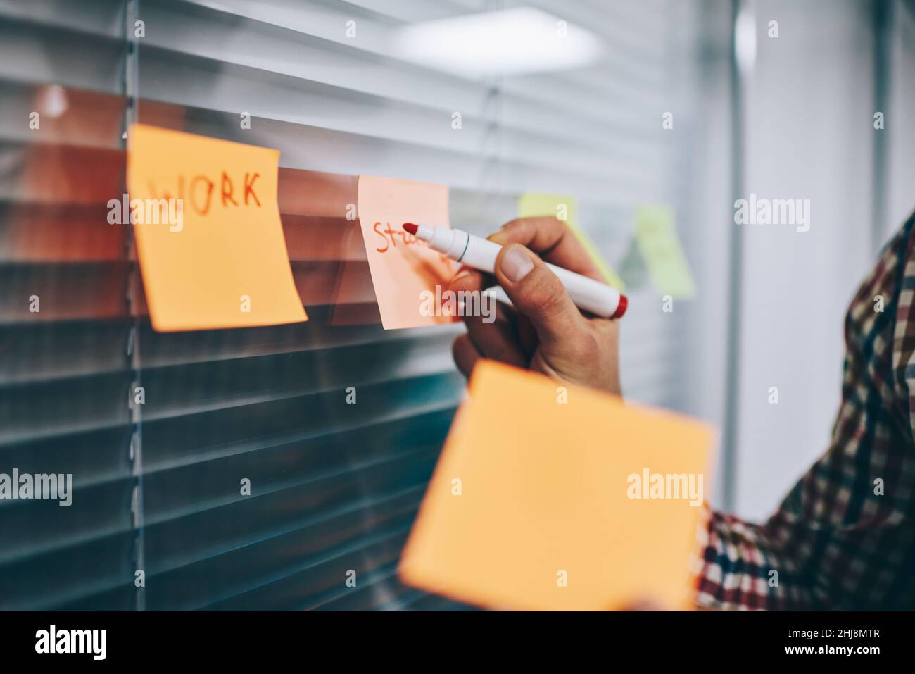 Anonymous man using marker on paper Stock Photo - Alamy