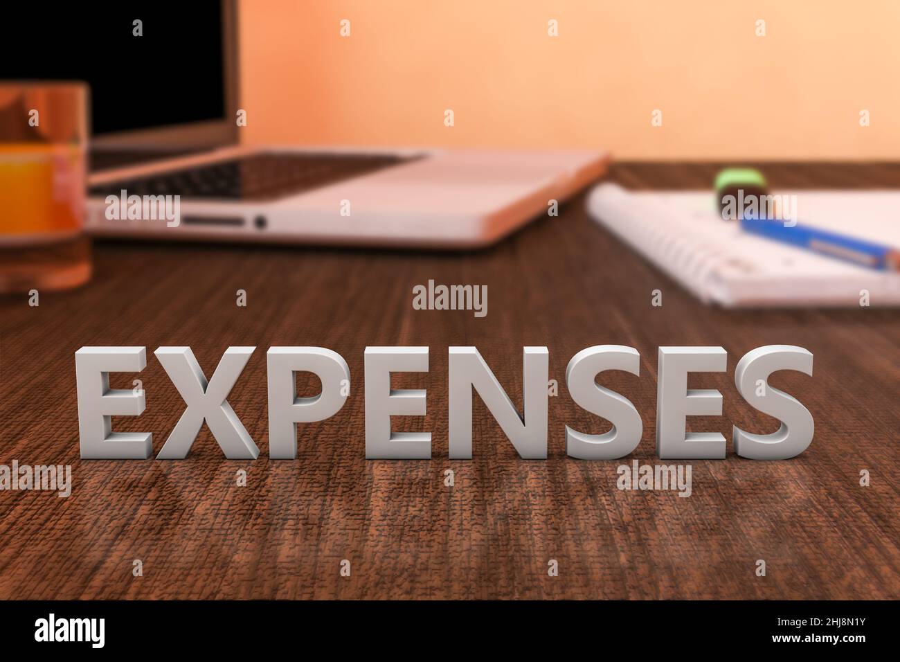 Expenses letters on wooden desk with laptop computer and a notebook