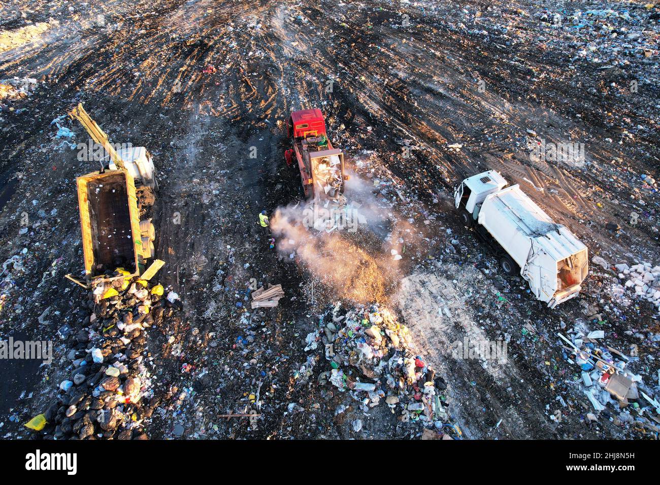 Garbage truck unloads rubbish in landfill. Landfill waste disposal