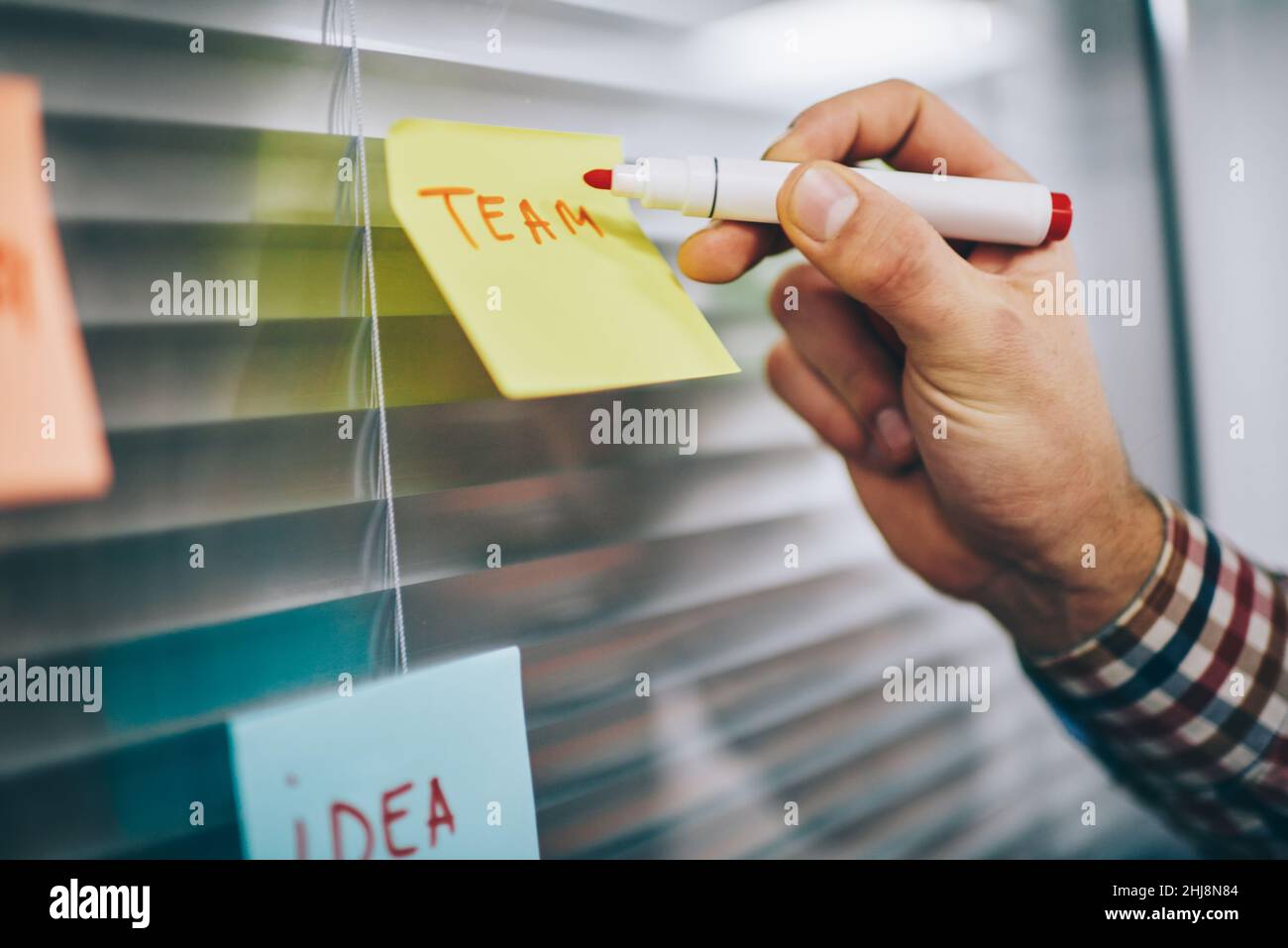 Faceless male worker making notes on paper Stock Photo