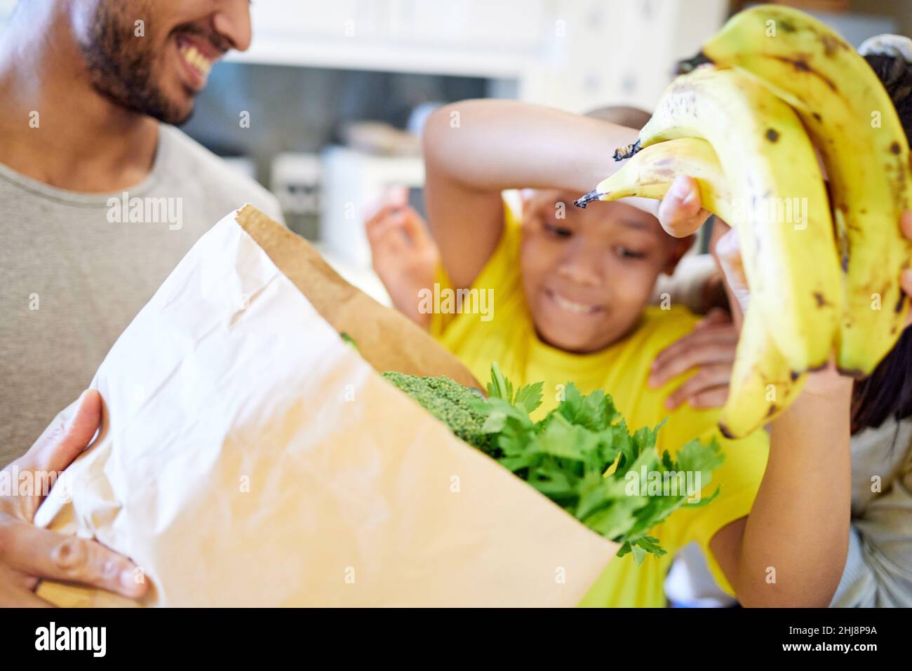 Healthy living. Shot of a family unpacking the groceries in the kitchen at home. Stock Photo