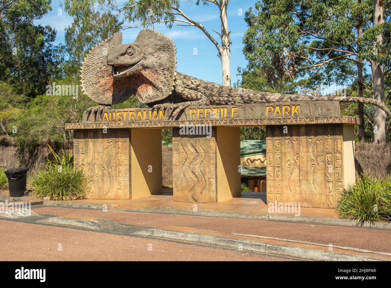 Entrance to the Australian Reptile Park with huge frilled dragon lizard sculpture on top located at Somersby on the Central Coast, New South Wales Stock Photo