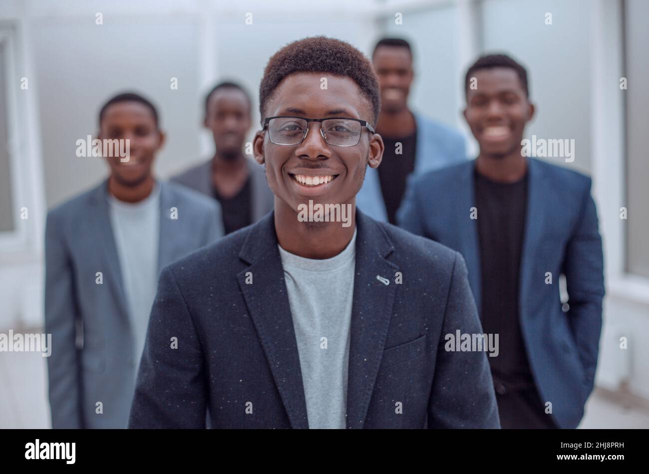 group of young business people standing in the office lobby Stock Photo ...