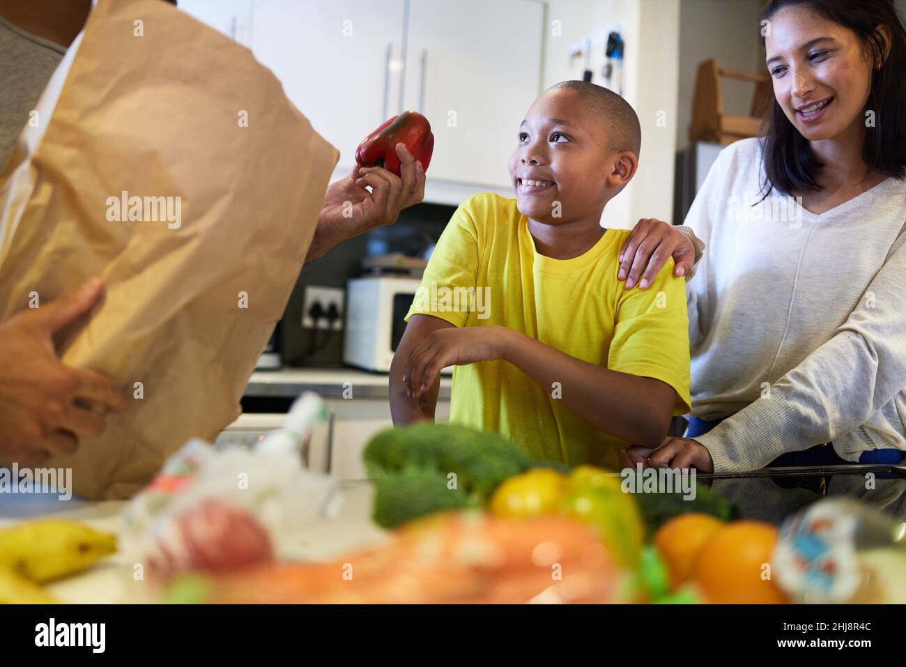 What's for supper. Shot of a family unpacking the groceries in the kitchen at home. Stock Photo