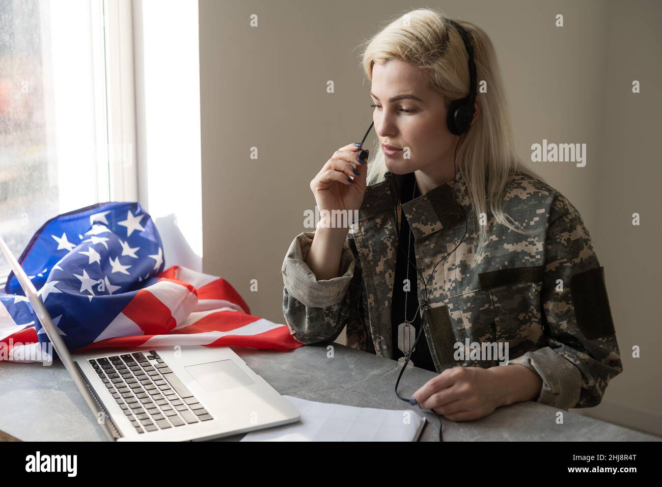 Young female soldier working with laptop in headquarters building Stock ...