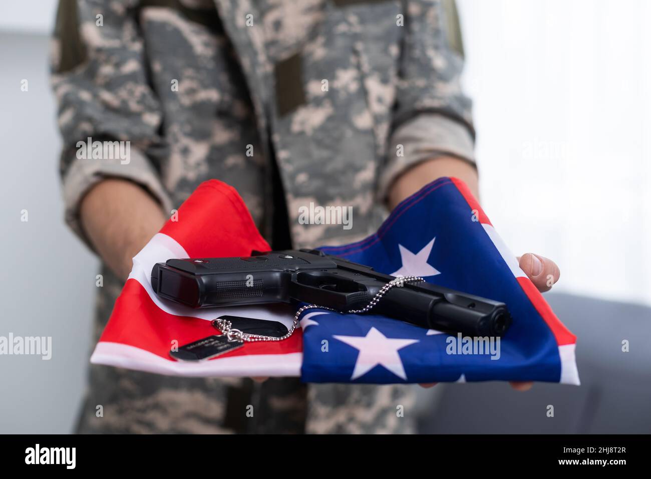 American soldier stands against white background with a flag. Concept ...